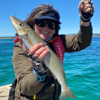 Steve Starlo's Wife with her latest King Whiting Catch in Ridgeline rain jacket